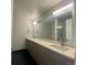 Elegant bathroom featuring a double sink vanity with stone countertop and a large mirror at 2718 Pine St # 305, Boulder, CO 80302