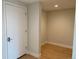 Clean entryway with light walls, wood floors, and neutral decor leading into another room at 2718 Pine St # 305, Boulder, CO 80302