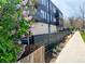 Modern apartment building with black wood and balconies along a sidewalk at 2718 Pine St # 305, Boulder, CO 80302