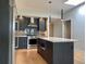 Modern kitchen features stainless steel appliances, grey cabinets, and a central island with white countertop at 2718 Pine St # 305, Boulder, CO 80302