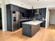 Modern kitchen with a large island, stainless steel appliances and dark cabinets at 2718 Pine St # 305, Boulder, CO 80302