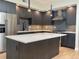 Stylish kitchen with island, stainless steel refrigerator, modern cabinets, and a stainless steel range hood at 2718 Pine St # 305, Boulder, CO 80302