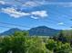 Scenic view from the property showcasing mountains, trees, and a bright blue sky with clouds at 2718 Pine St # 305, Boulder, CO 80302