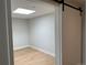Bright, unfurnished room featuring a skylight, light wood floors, and a sliding barn door at 2718 Pine St # 305, Boulder, CO 80302