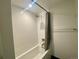 This shower features white tile, a shower curtain, and a modern shower head at 2718 Pine St # 305, Boulder, CO 80302