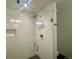 Modern shower featuring glass doors, white tile, and a contemporary shower head at 2718 Pine St # 305, Boulder, CO 80302