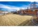 Expansive backyard featuring lush grass, a brick home exterior, and secure fencing at 9241 Knox Ct, Westminster, CO 80031