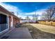 Spacious backyard with a concrete patio area and a combination of wood and vinyl fencing at 9241 Knox Ct, Westminster, CO 80031