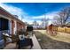 The backyard has a seating area and a playhouse/swingset at 9241 Knox Ct, Westminster, CO 80031