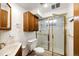 Bathroom featuring a shower with glass doors, vanity, toilet and storage cabinet at 9241 Knox Ct, Westminster, CO 80031