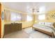 A primary bedroom features neutral walls and bedding, a ceiling fan, and many windows at 9241 Knox Ct, Westminster, CO 80031