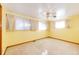 A large bedroom features neutral carpet, a ceiling fan, and many windows at 9241 Knox Ct, Westminster, CO 80031