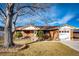 Charming brick home featuring a well-manicured lawn and attached garage at 9241 Knox Ct, Westminster, CO 80031