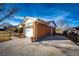 Brick home with attached garage and concrete driveway at 9241 Knox Ct, Westminster, CO 80031