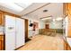 A bright kitchen features wood cabinets and a refrigerator with water and ice dispenser and an open floor plan at 9241 Knox Ct, Westminster, CO 80031