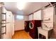 Well-equipped laundry room with modern washer and dryer, sink, and storage cabinets at 9241 Knox Ct, Westminster, CO 80031