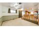 An open living room features neutral carpet, a ceiling fan, and access to the kitchen at 9241 Knox Ct, Westminster, CO 80031