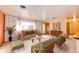Bright, staged living room with neutral tones and large windows at 9241 Knox Ct, Westminster, CO 80031