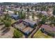 Aerial shot showcasing a spacious backyard with a wooden fence, garden area, and multiple storage sheds at 576 S Tabor St, Elizabeth, CO 80107