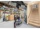 Unfinished basement area with shelving, stairs to main level, and potential for customization at 576 S Tabor St, Elizabeth, CO 80107