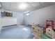 Unfinished basement with a dartboard and play area providing versatile space for activities at 576 S Tabor St, Elizabeth, CO 80107