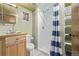 Functional bathroom with a shower, shelving, and classic fixtures at 576 S Tabor St, Elizabeth, CO 80107