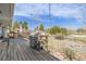 Outdoor wooden deck featuring a built-in grill and a cozy fire pit area, perfect for entertaining at 576 S Tabor St, Elizabeth, CO 80107