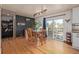 Bright dining room with hardwood floors, track lighting, and a sliding glass door to the outdoor space at 576 S Tabor St, Elizabeth, CO 80107