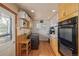 Cozy kitchen area with laundry, offering convenient access to appliances and workspace at 576 S Tabor St, Elizabeth, CO 80107