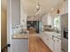Galley kitchen with white cabinetry, granite counters, farmhouse sink, and stainless steel appliances at 576 S Tabor St, Elizabeth, CO 80107
