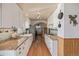 Bright kitchen with white cabinetry, granite countertops, farmhouse sink, and hardwood floors at 576 S Tabor St, Elizabeth, CO 80107