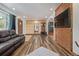 Spacious living room with wood accents, a leather sofa, and archways leading to other areas of the home at 576 S Tabor St, Elizabeth, CO 80107