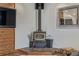 Living room featuring a wood-burning stove, unique decor, and wood accents for a cozy, rustic feel at 576 S Tabor St, Elizabeth, CO 80107