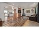 Cozy living room featuring hardwood floors, a wood-burning stove, a TV, and lots of natural light at 576 S Tabor St, Elizabeth, CO 80107