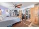 Spacious primary bedroom with a ceiling fan, wood accents, and access to the ensuite bathroom at 576 S Tabor St, Elizabeth, CO 80107