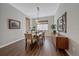 Bright dining room features hardwood floors and a mid-century modern sideboard at 22537 E Swallow Pl, Aurora, CO 80016