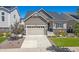 House exterior featuring a two-car garage and well-manicured lawn at 22537 E Swallow Pl, Aurora, CO 80016