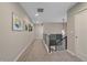 Upstairs hallway with modern light fixture and carpet at 22537 E Swallow Pl, Aurora, CO 80016