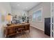 Home office with built-in shelving and large window at 22537 E Swallow Pl, Aurora, CO 80016