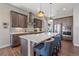 Sleek kitchen with dark cabinetry, a large island, and high-end appliances at 22537 E Swallow Pl, Aurora, CO 80016