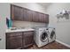 Laundry room with washer, dryer, and upper cabinets at 22537 E Swallow Pl, Aurora, CO 80016