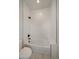 Bathroom featuring a tub and toilet with white subway tile surround and sleek fixtures at 1372 Lowell Blvd # 4, Denver, CO 80204