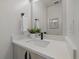 Chic bathroom with quartz countertop vanity, decorative plant, and framed mirror at 1372 Lowell Blvd # 4, Denver, CO 80204