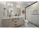 Beautiful bathroom with double vanity, modern lighting, and a glass-enclosed shower at 1372 Lowell Blvd # 4, Denver, CO 80204