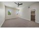Spacious bedroom with plush carpet, two windows, ceiling fan, and a walk-in closet at 1372 Lowell Blvd # 4, Denver, CO 80204