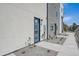 Modern townhome featuring a bright blue front door and manicured landscaping with fresh decorative rock at 1372 Lowell Blvd # 4, Denver, CO 80204