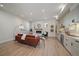 Open-concept living room and kitchen featuring hardwood floors, a fireplace and modern appliances at 1372 Lowell Blvd # 4, Denver, CO 80204
