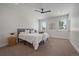 Bright main bedroom with modern ceiling fan, plush carpet, and two sunny windows at 1372 Lowell Blvd # 4, Denver, CO 80204