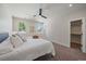 Sunny main bedroom with a ceiling fan, plush carpet, bright windows, and a closet at 1372 Lowell Blvd # 4, Denver, CO 80204
