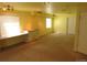 Finished basement area with built-in desk, lighting, and neutral carpet at 3212 S Kirk Way, Aurora, CO 80013